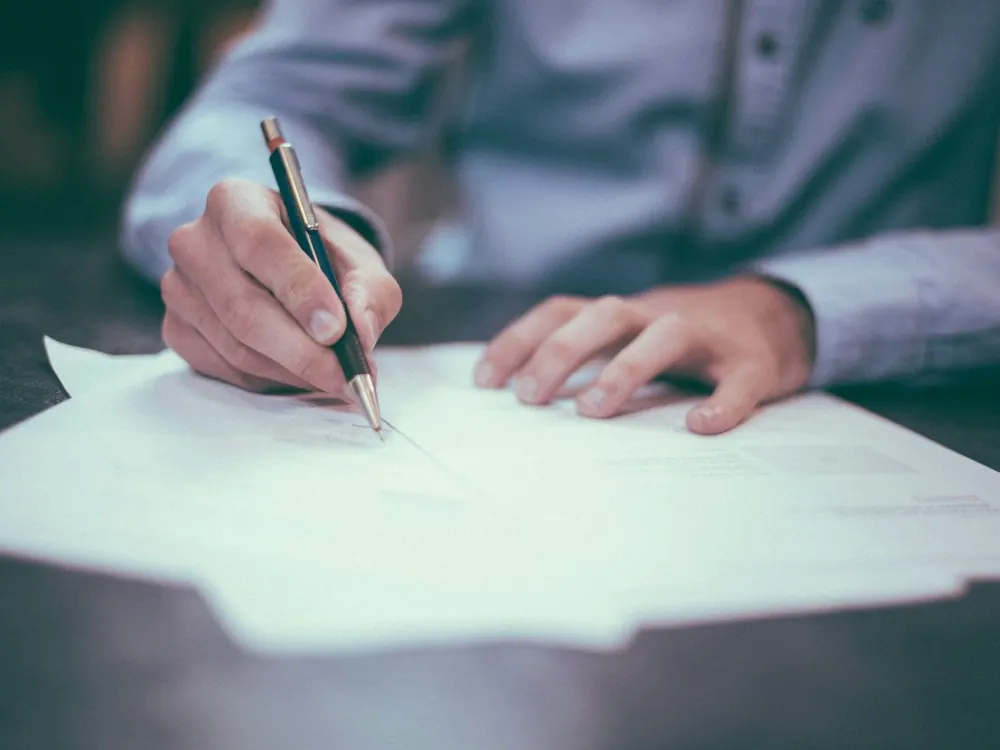 Un notaire signe un acte de succession